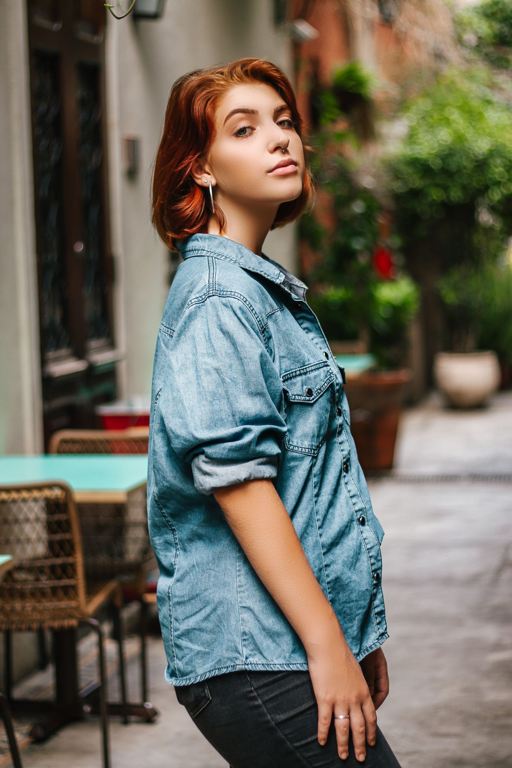 Woman wearing a denim shirt and jeans outdoors on a city street